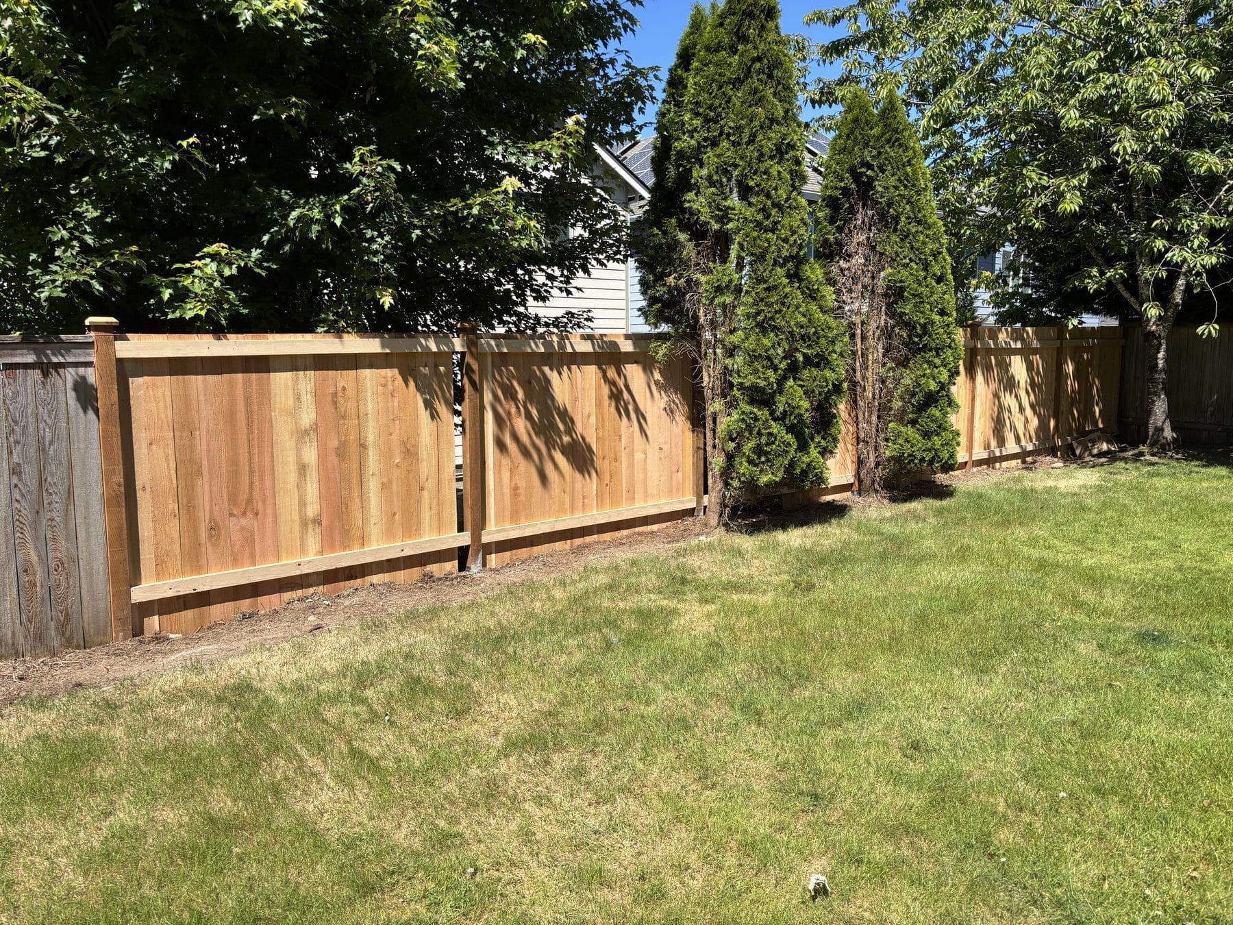 Completed 45 foot estate cedar fence in a landscaped Bothell yard