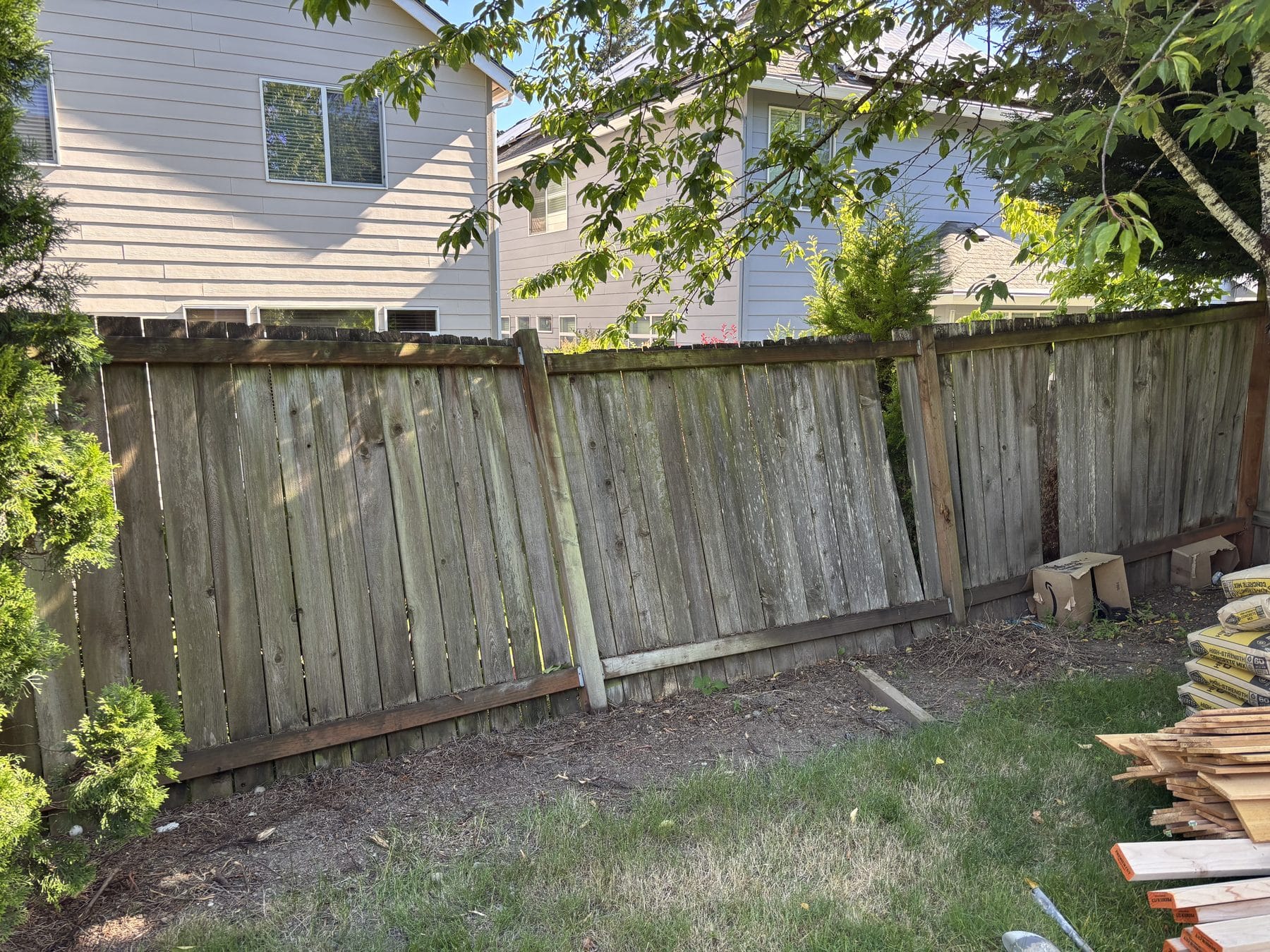 Leaning fence panels before estate fence replacement in Bothell