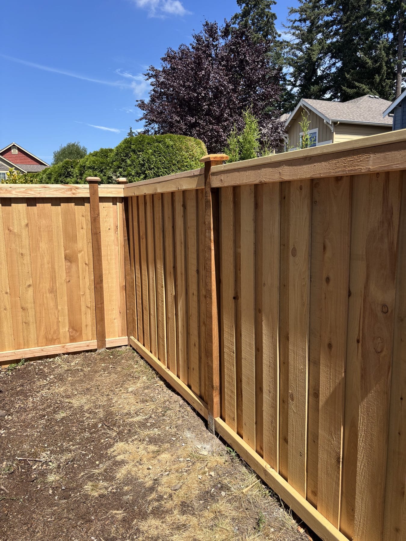 Cedar board-on-board fence corner following a Bothell yard