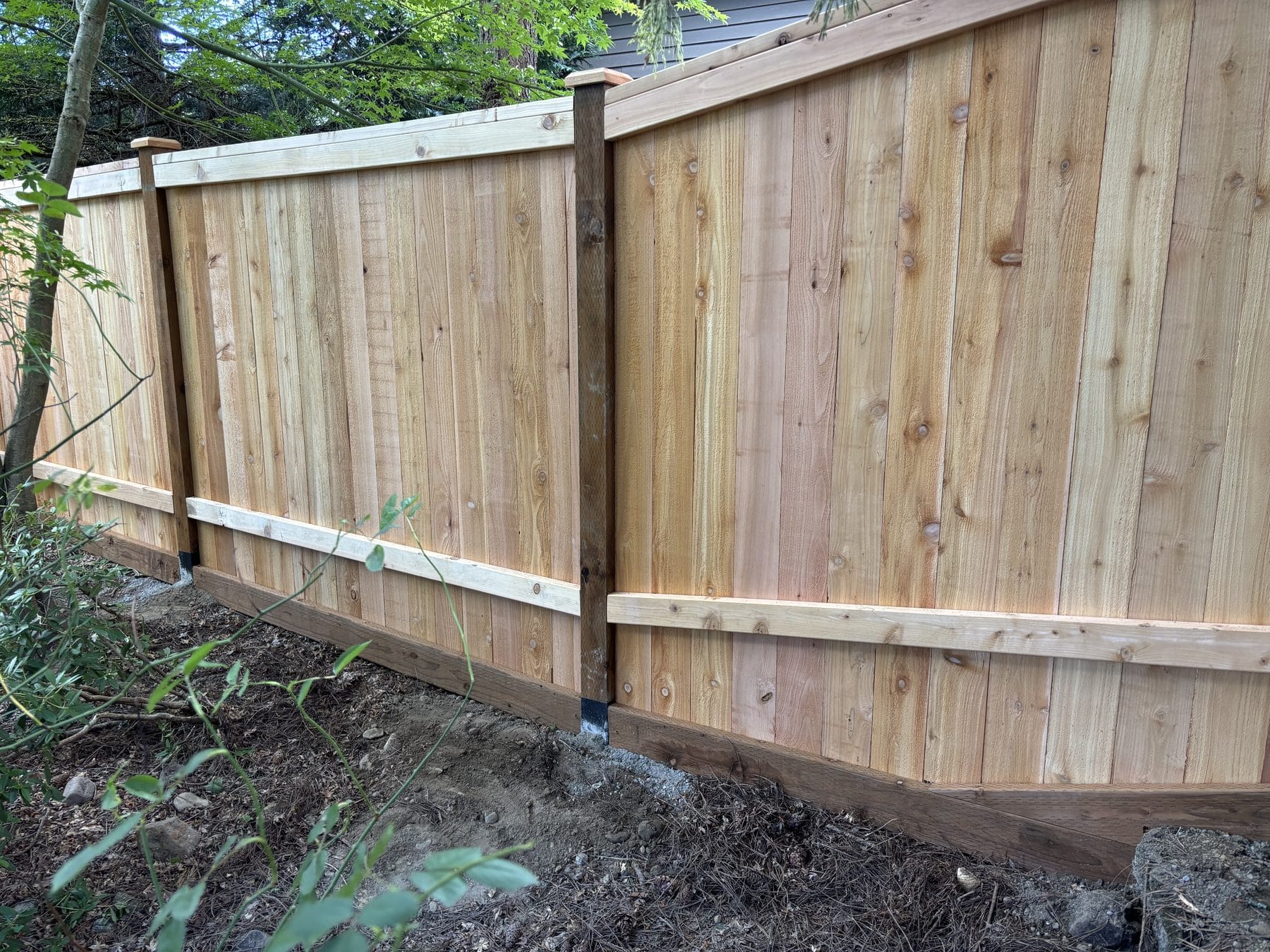 Capped cedar posts and full-panel fence detail in Kirkland WA