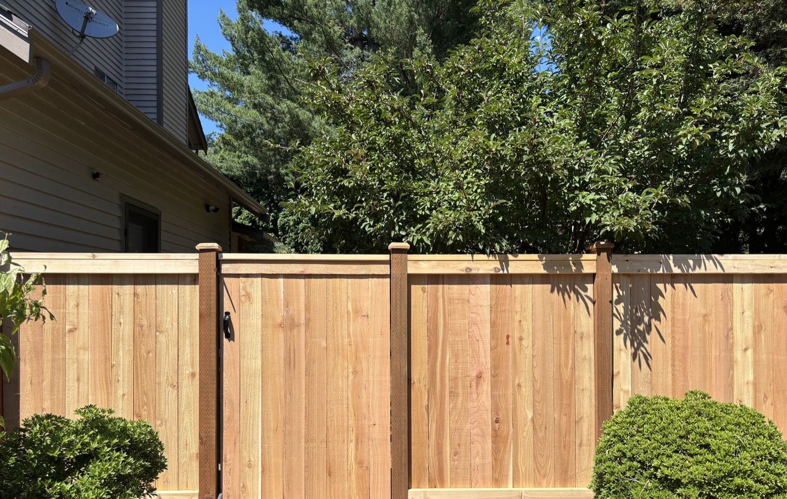New custom cedar gate integrated with full-panel fence in Redmond WA