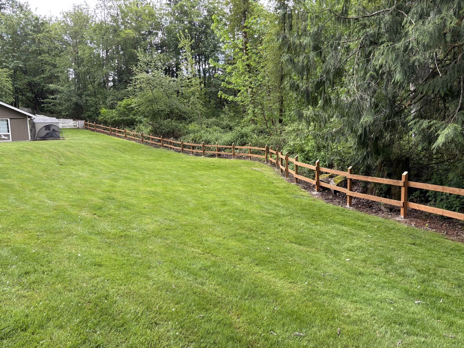 Long 480 foot cedar ranch fence installed on a sloped Sammamish property