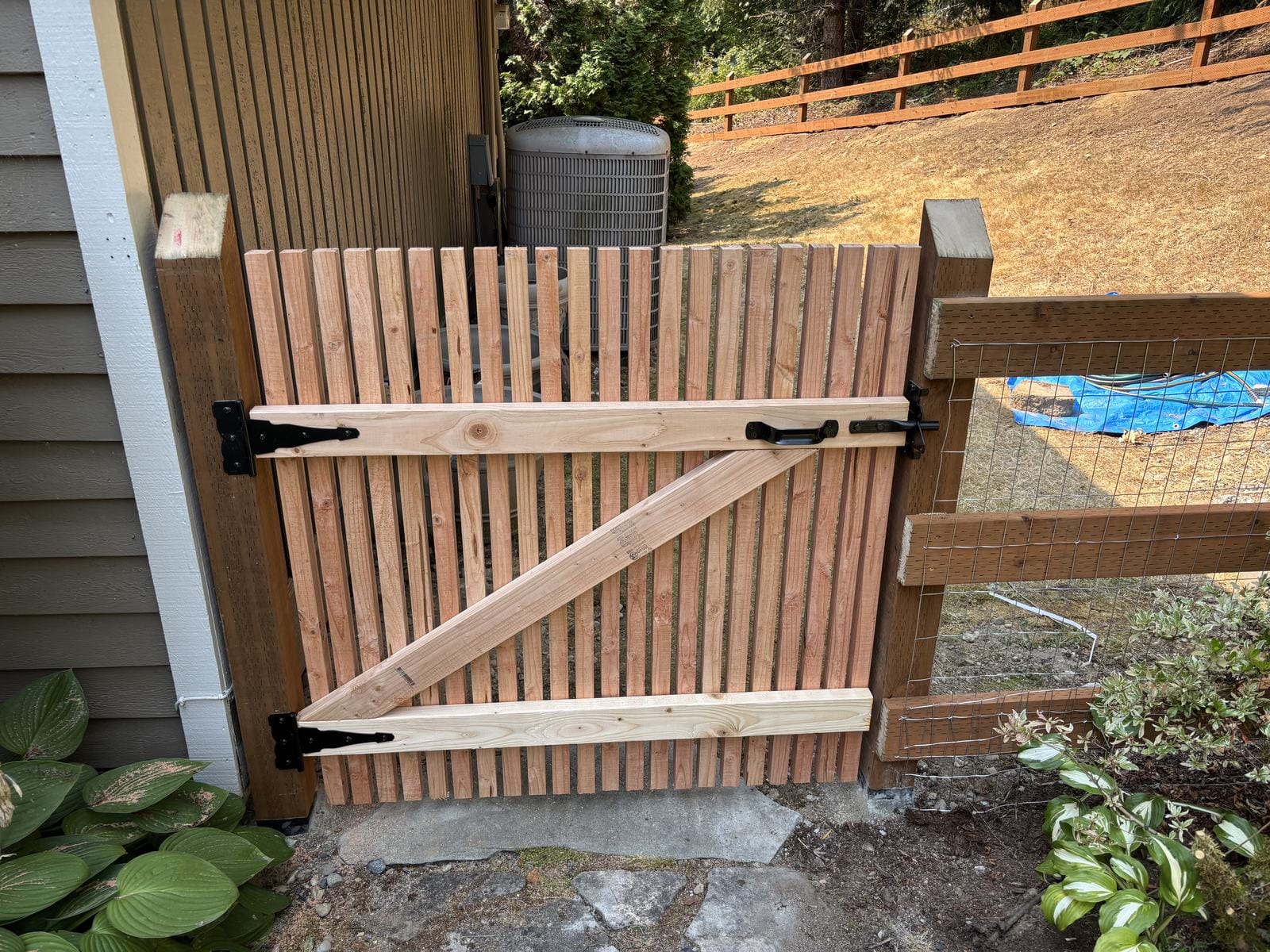Close view of custom cedar fence gate and black hardware in Sammamish WA