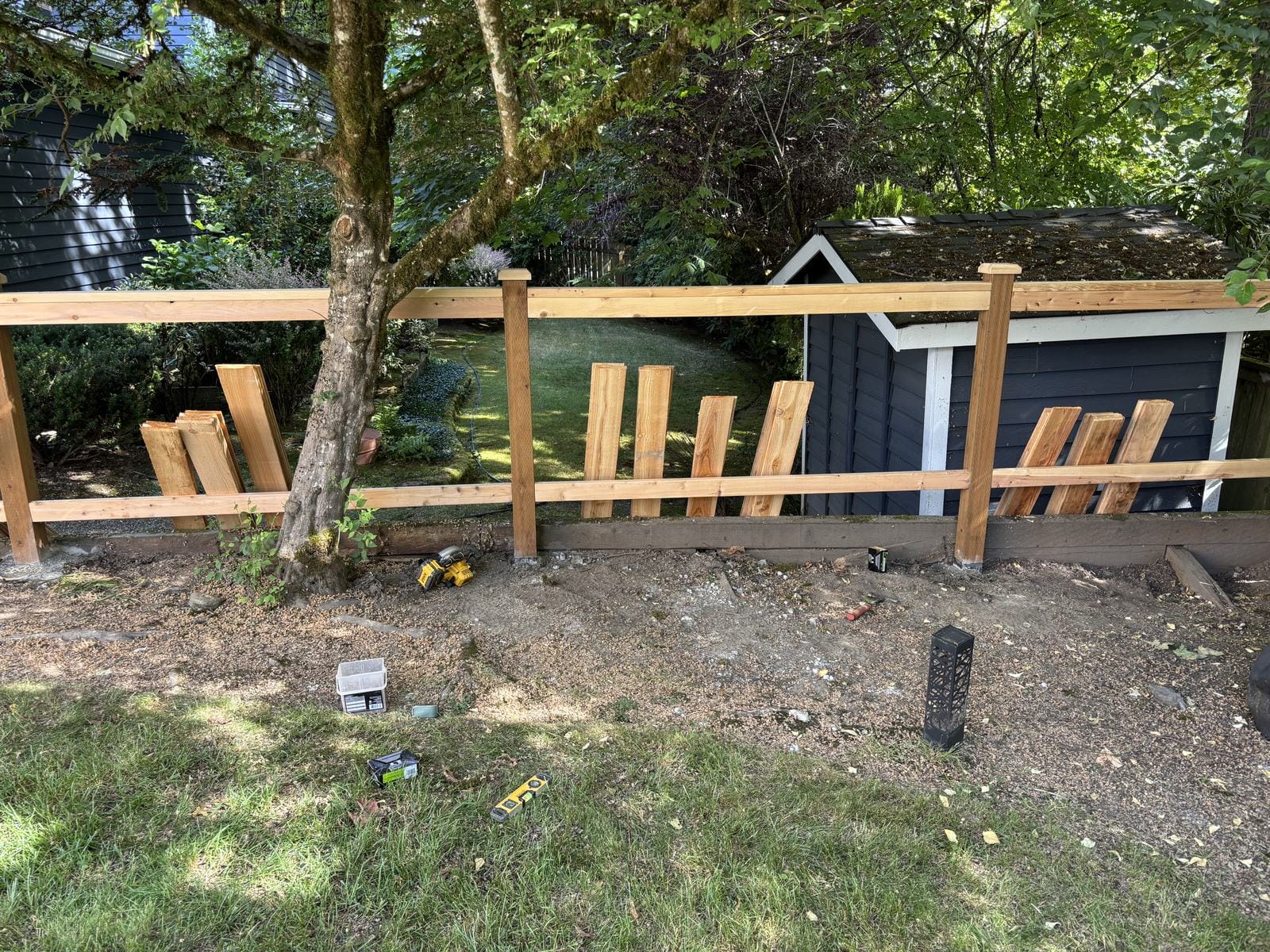 Five foot full-panel cedar fence during construction in Sammamish WA