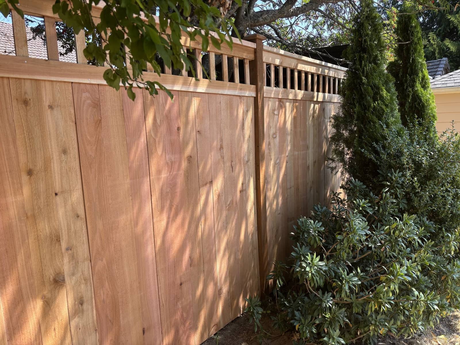 Seven-foot decorative open-top cedar fence after installation